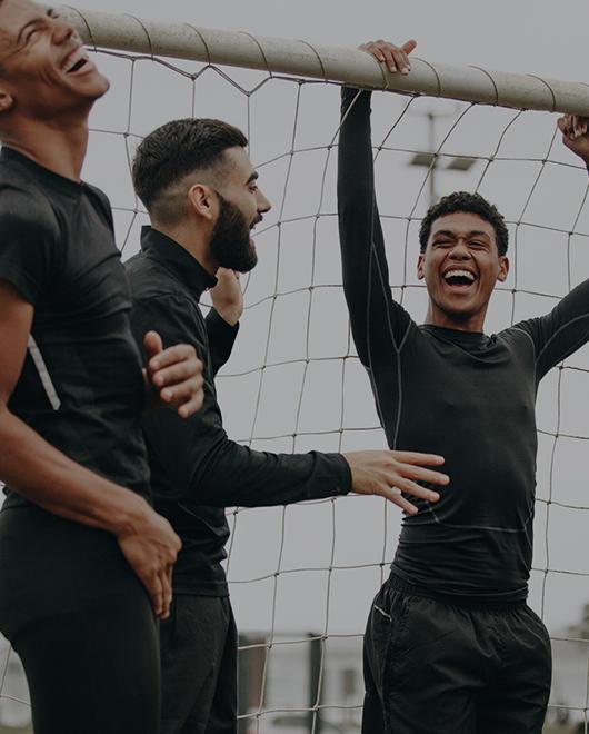  Group of young men laughing and training soccer